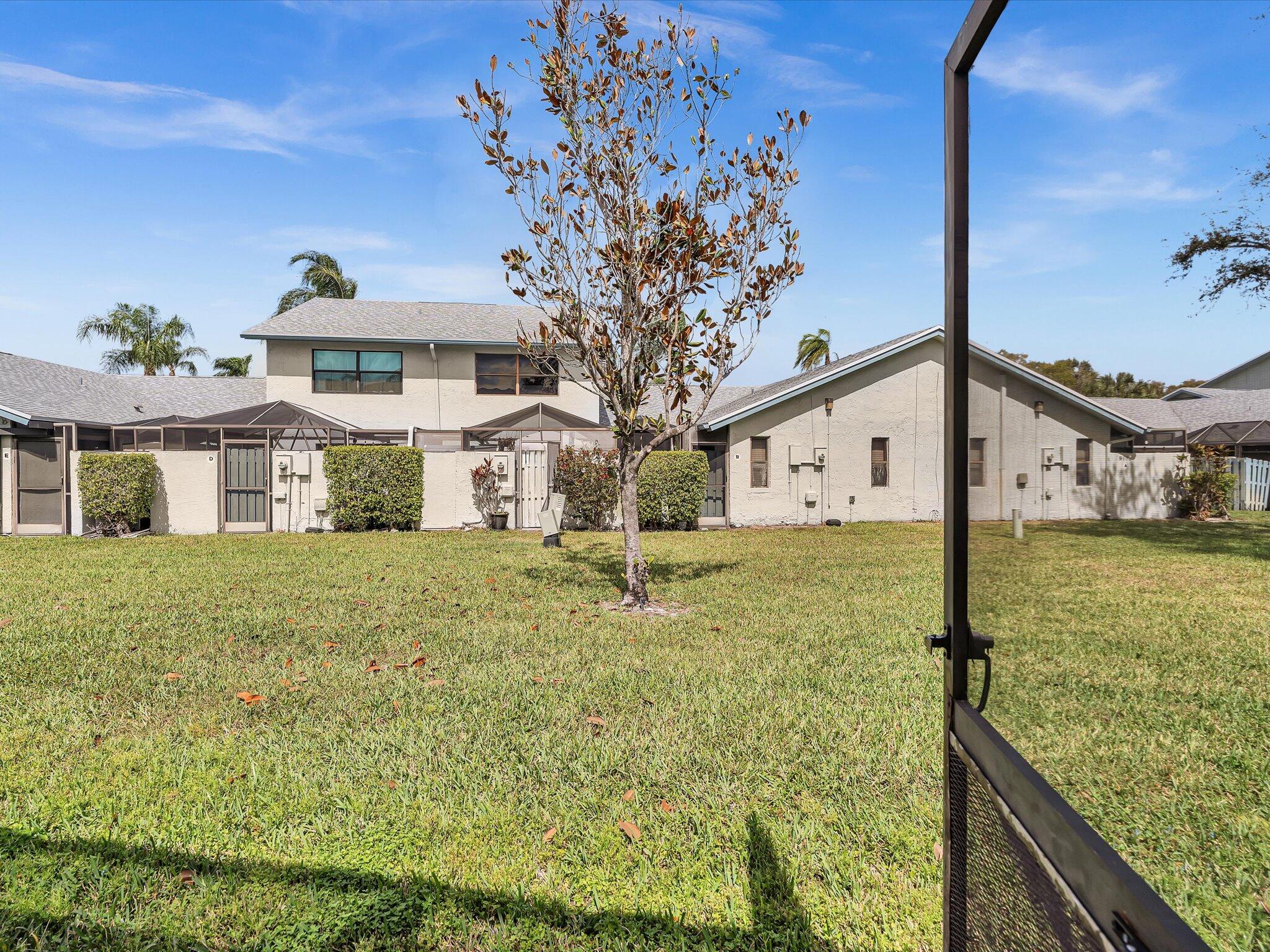 9095 Southwest 21st Court, Unit D Boca Raton, FL 33428 - Photo 17 of 36 a front view of a house with garden