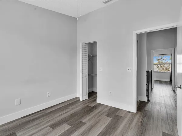 wooden floor in a hall with an empty room