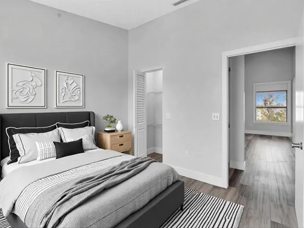 a bedroom with a bed and wooden floor