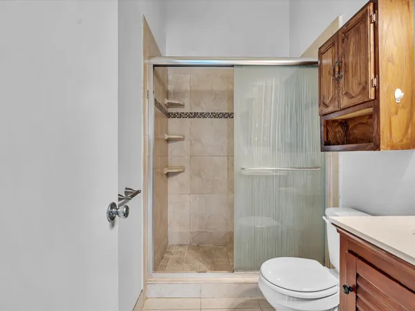 a bathroom with a shower a toilet and a sink