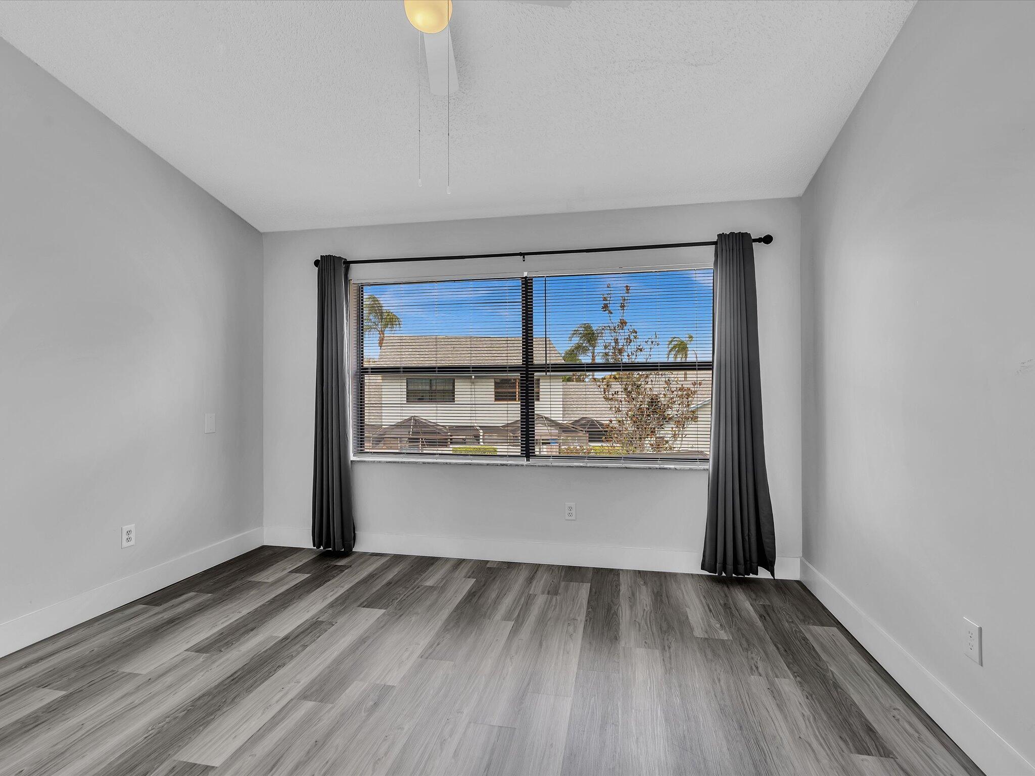 9095 Southwest 21st Court, Unit D Boca Raton, FL 33428 - Photo 24 of 36 a view of a kitchen with wooden floor and a sink