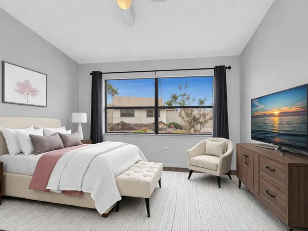 a bedroom with a bed and a flat screen tv