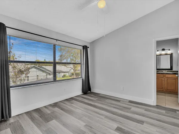 a view of a livingroom with wooden floor and a window