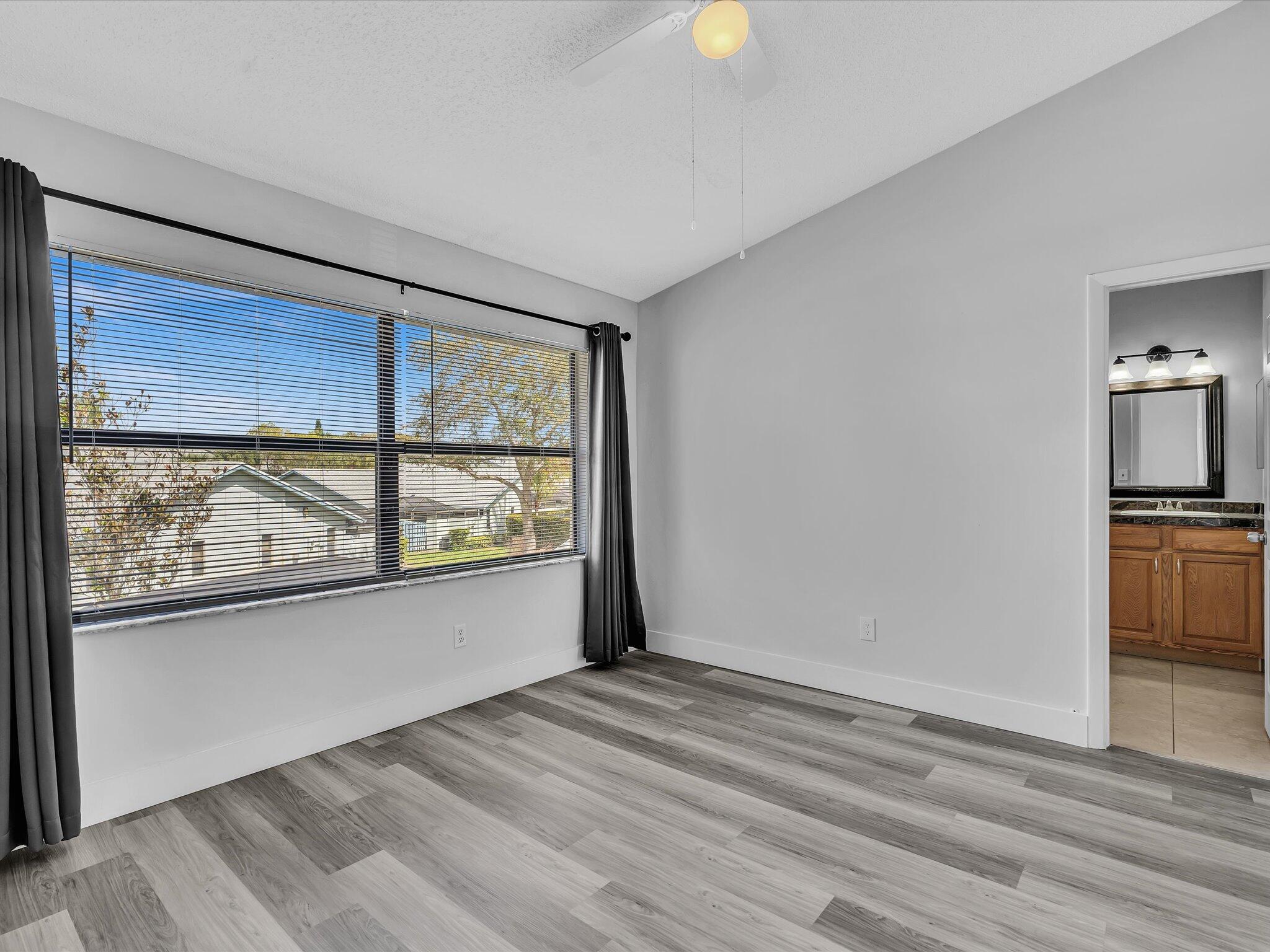 9095 Southwest 21st Court, Unit D Boca Raton, FL 33428 - Photo 26 of 36 a view of a livingroom with wooden floor and a window