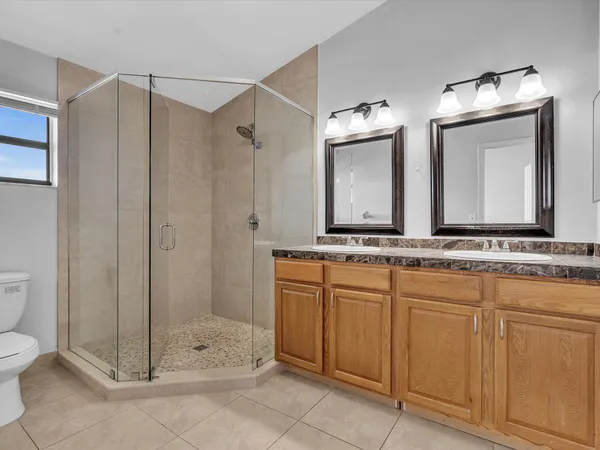 a bathroom with a toilet a sink and shower