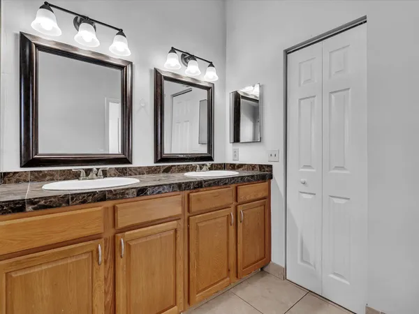 a bathroom with a double vanity sink and a mirror