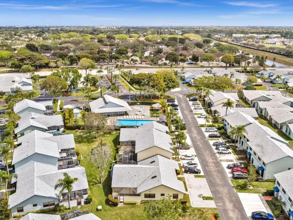 an aerial view of residential building with parking