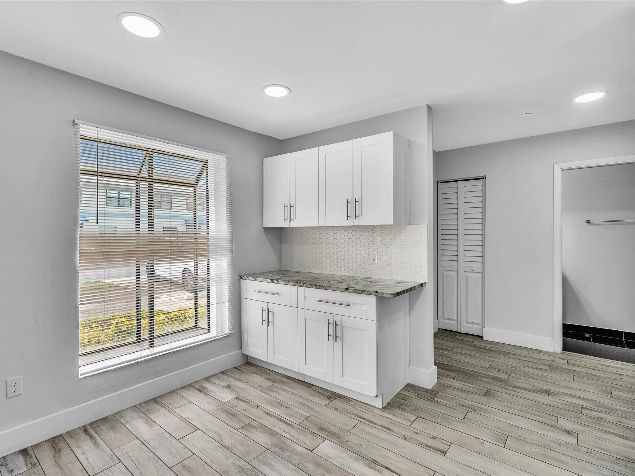 9095 Southwest 21st Court, Unit D Boca Raton, FL 33428 - Photo 4 of 36 a kitchen with stainless steel appliances granite countertop a stove a sink and a refrigerator