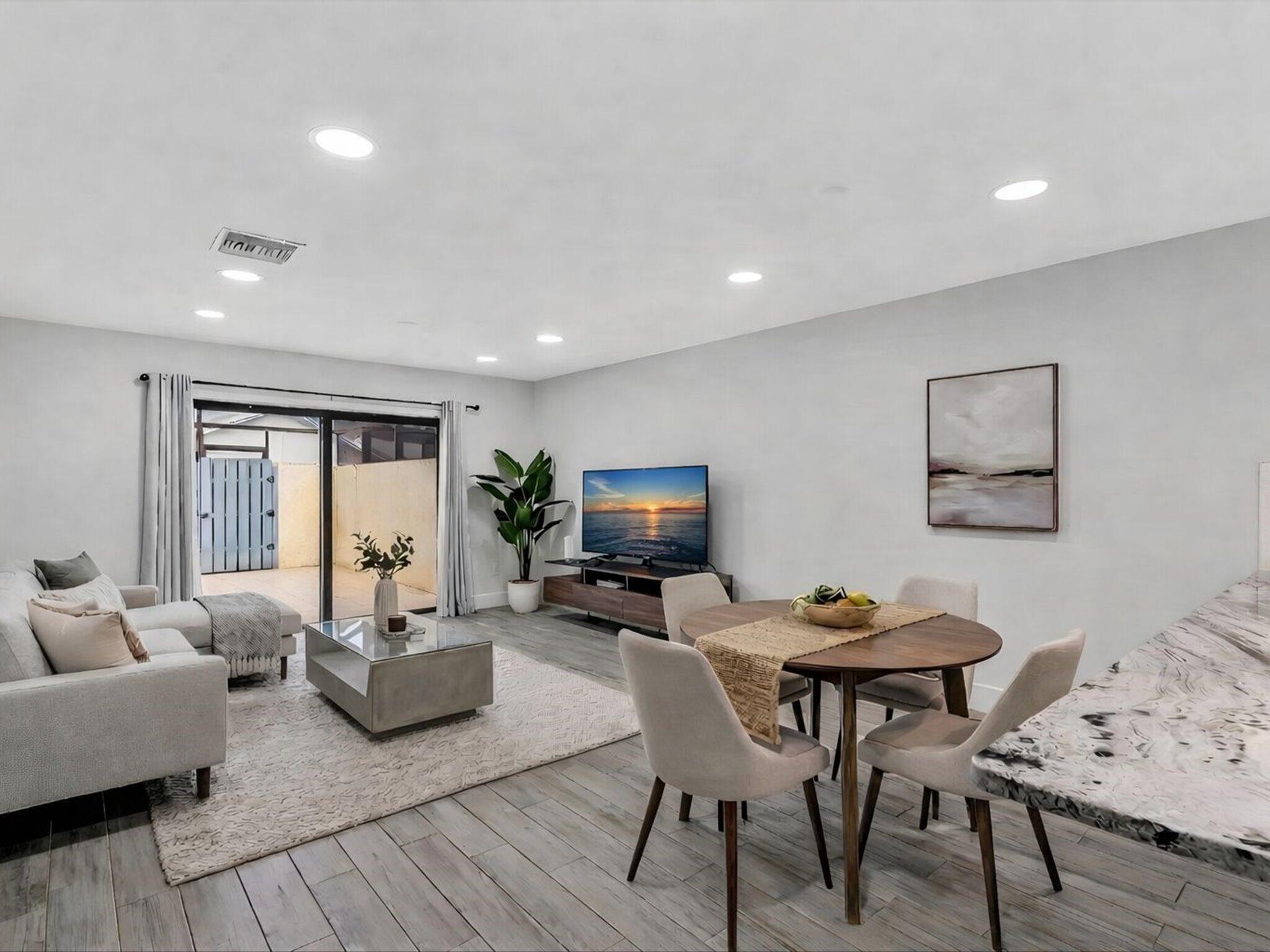 9095 Southwest 21st Court, Unit D Boca Raton, FL 33428 - Photo 6 of 36 a living room with furniture and a flat screen tv