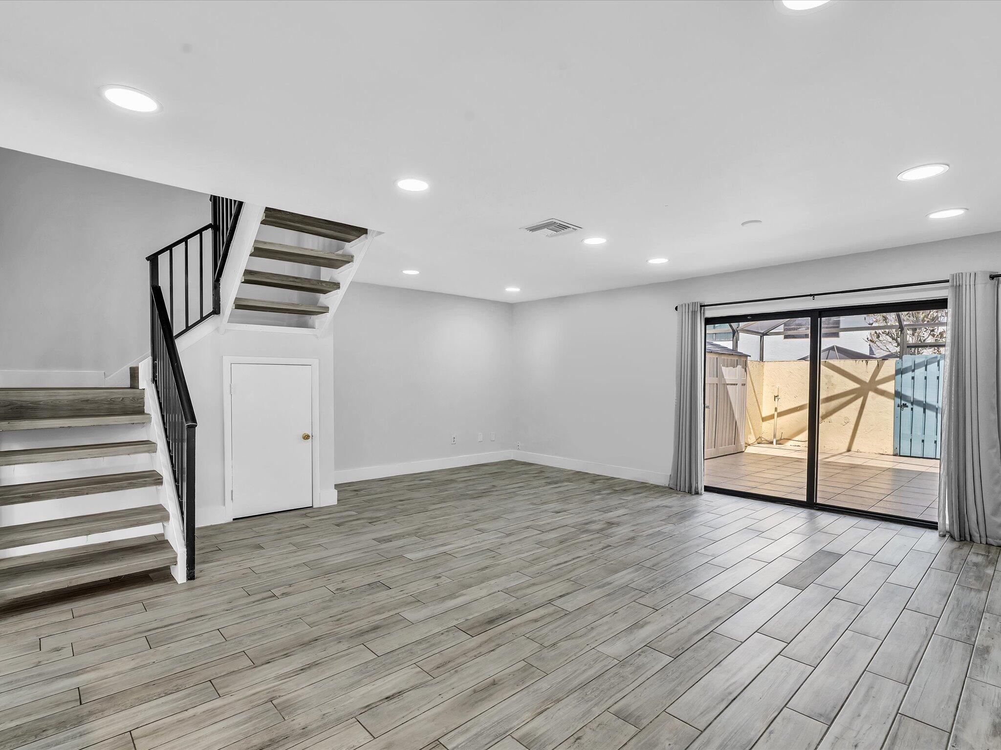 9095 Southwest 21st Court, Unit D Boca Raton, FL 33428 - Photo 7 of 36 wooden floor in an empty room with a window