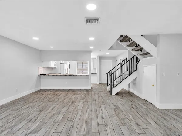 a view of kitchen with wooden floor and electronic appliances