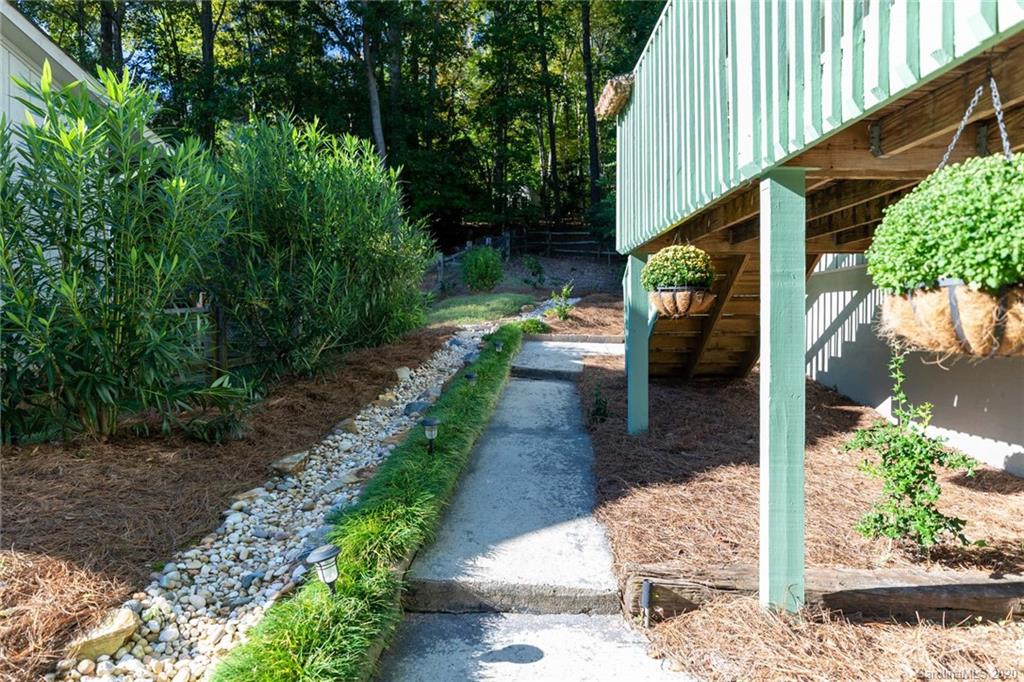 16156 Tana Tea Circle Fort Mill, SC 29708 - Photo 5 of 29 a view of a patio with table and chairs potted plants with wooden fence
