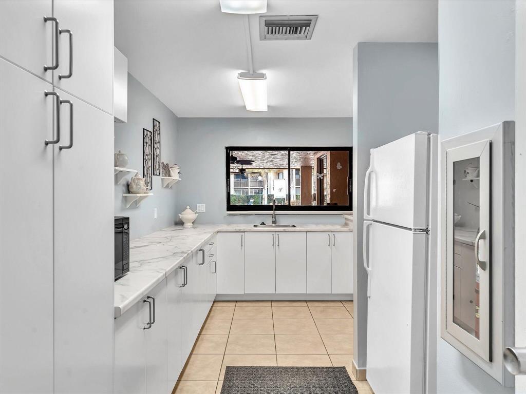 2209 Southwest 15th Street, Unit 241 Deerfield Beach, FL 33442 - Photo 39 of 46 clubhouse kitchen