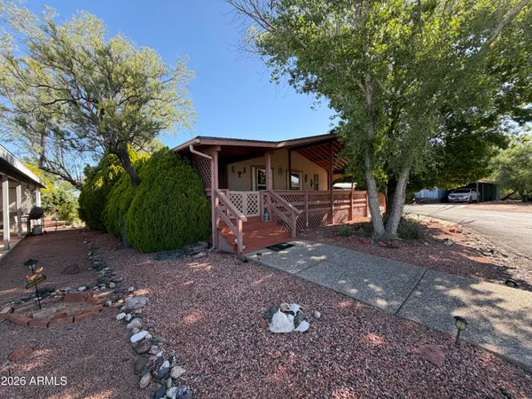 a view of a house with backyard and a tree