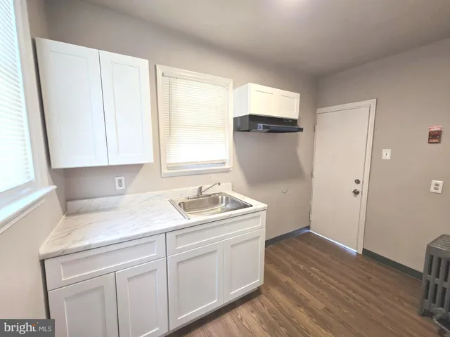 a kitchen with a sink cabinets appliances and a window