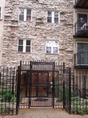 6954 North Greenview Avenue, Unit 305 Chicago, IL 60626 - Photo 1 of 12 a view of a brick house and wooden fence