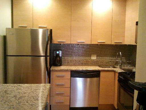 6954 North Greenview Avenue, Unit 305 Chicago, IL 60626 - Photo 3 of 12 a kitchen with a sink a refrigerator freezer and a stove