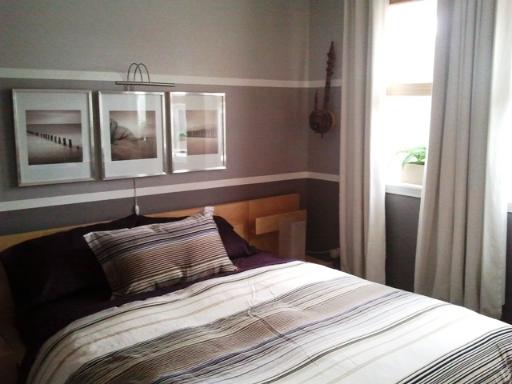 6954 North Greenview Avenue, Unit 305 Chicago, IL 60626 - Photo 7 of 12 a bedroom with a large bed and a window