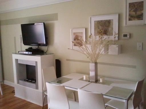6954 North Greenview Avenue, Unit 305 Chicago, IL 60626 - Photo 8 of 12 a living room with furniture and a flat screen tv