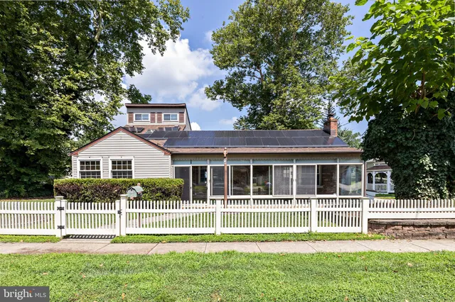 a front view of a house with a garden and plants