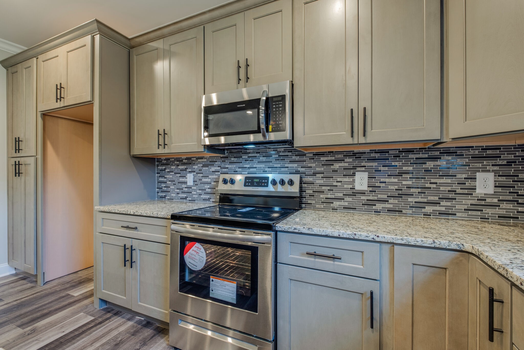 553 Cedar Grove Road Lebanon, TN 37087 - Photo 12 of 12 a kitchen with stainless steel appliances granite countertop a stove a sink and a microwave