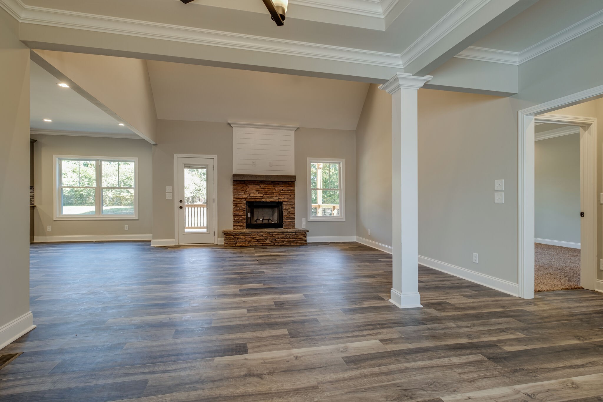 553 Cedar Grove Road Lebanon, TN 37087 - Photo 6 of 12 an empty room with wooden floor fireplace and windows