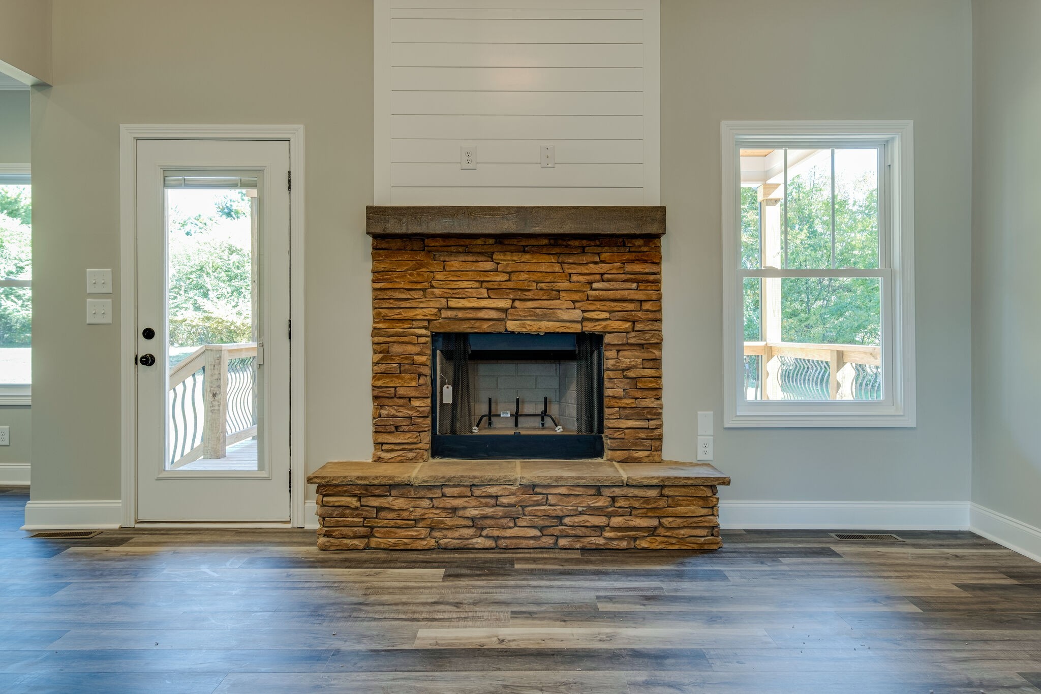 553 Cedar Grove Road Lebanon, TN 37087 - Photo 7 of 12 an empty room with wooden floor a fireplace and windows