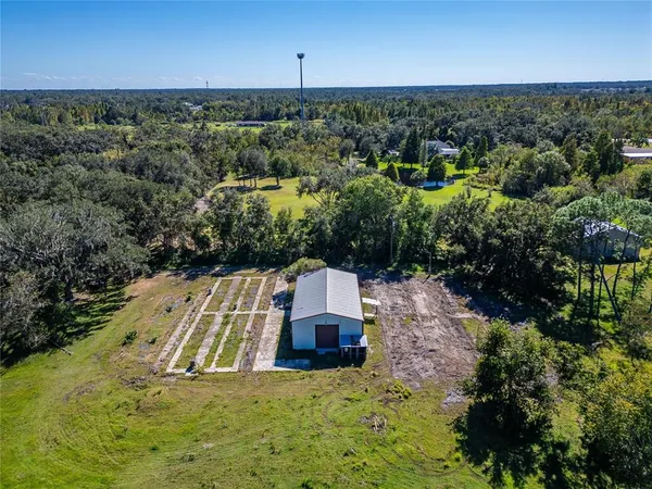an aerial view of a house with a yard and lake view