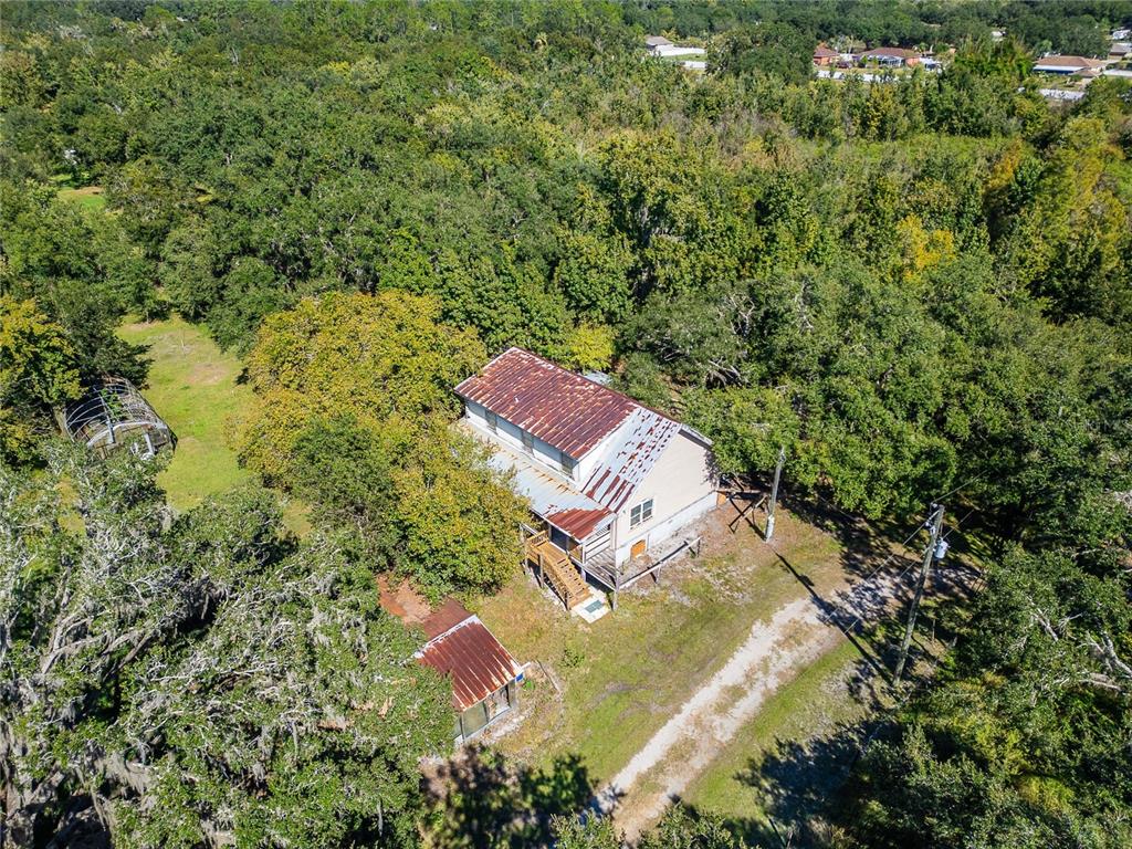 6930 Muck Pond Road Seffner, FL 33584 - Photo 32 of 37 an aerial view of residential house with outdoor space and trees all around