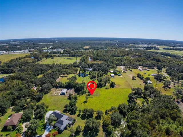 an aerial view of residential house with outdoor space and swimming pool