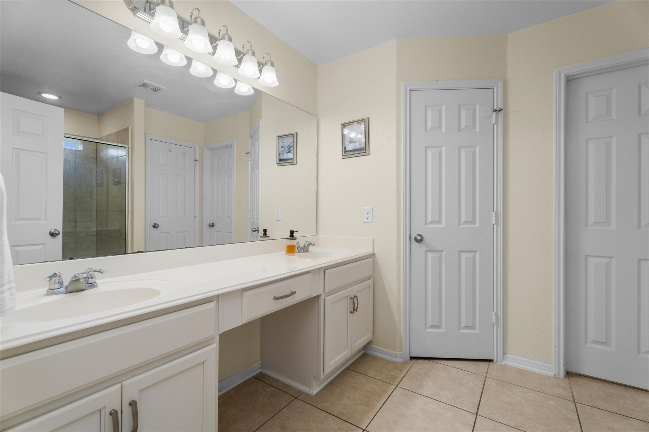 2615 Magnolia Fair Way Spring, TX 77386 - Photo 13 of 22 a bathroom with a sink a mirror and a shower