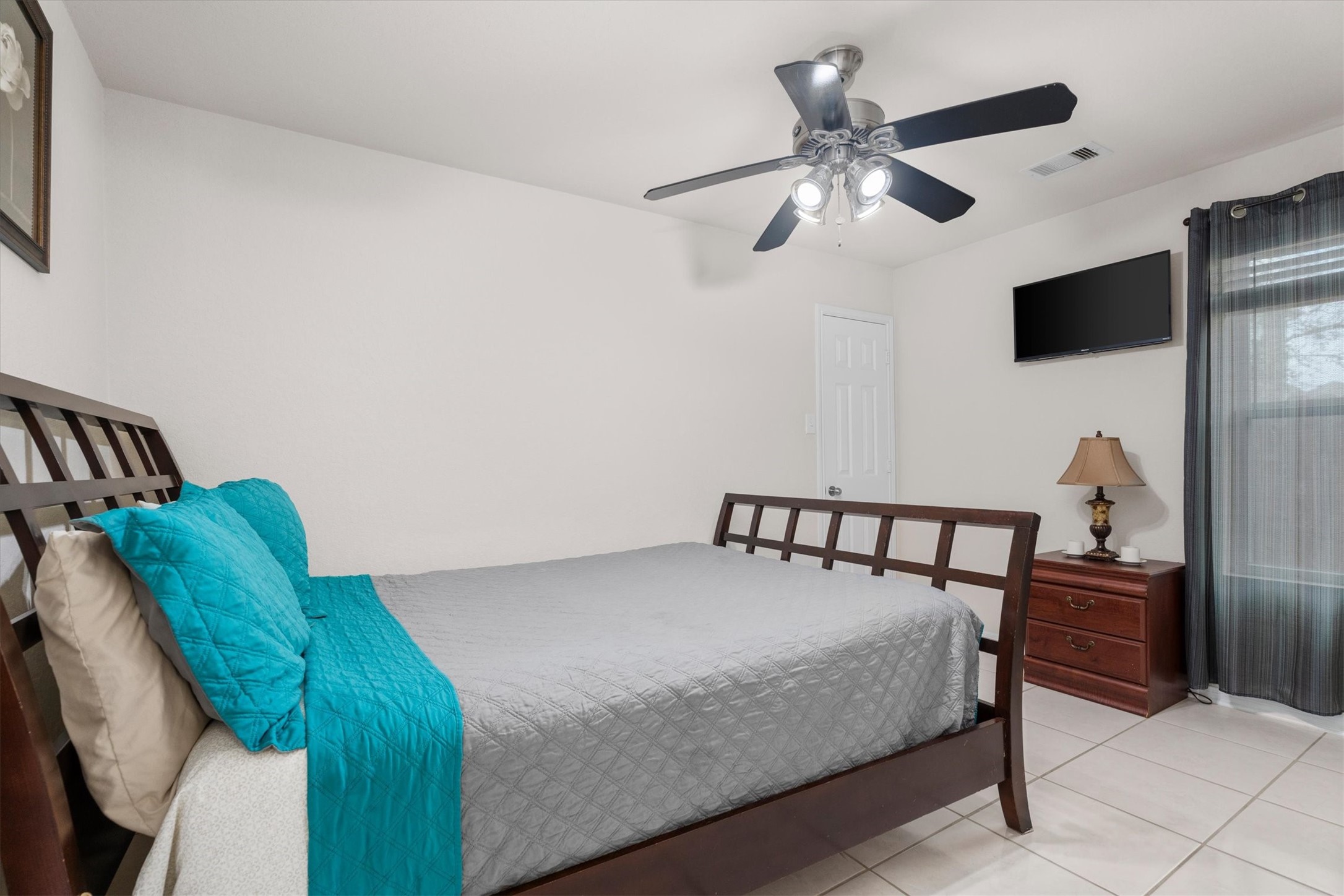 2615 Magnolia Fair Way Spring, TX 77386 - Photo 17 of 22 a bedroom with a bed and a chandelier