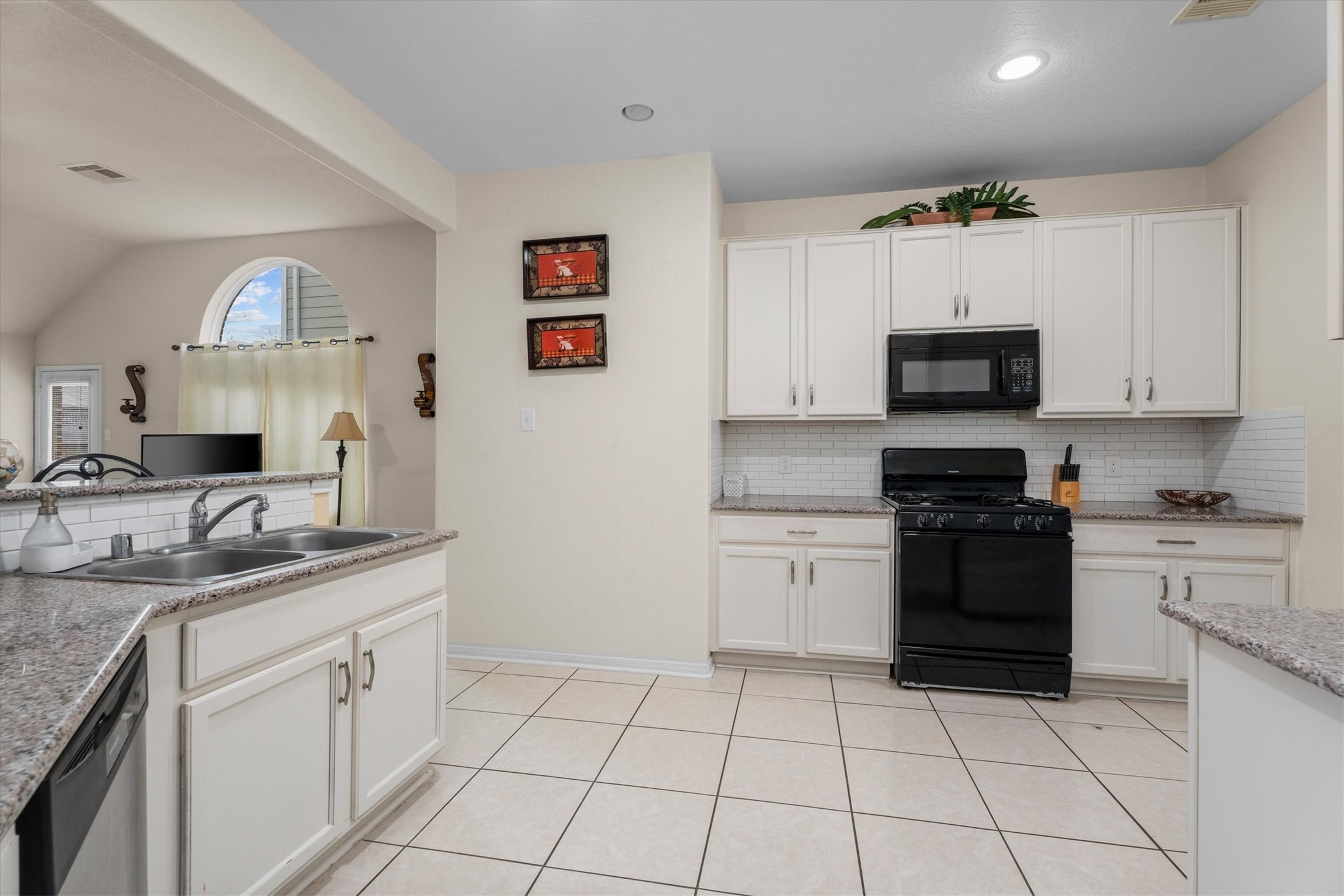 2615 Magnolia Fair Way Spring, TX 77386 - Photo 6 of 22 a kitchen with a sink stove and cabinets