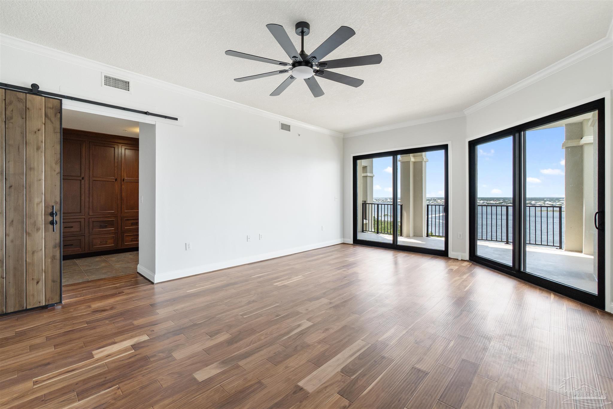 14900 River Road, Unit 904 Pensacola, FL 32507 - Photo 17 of 17 a view of an empty room with a window and wooden floor