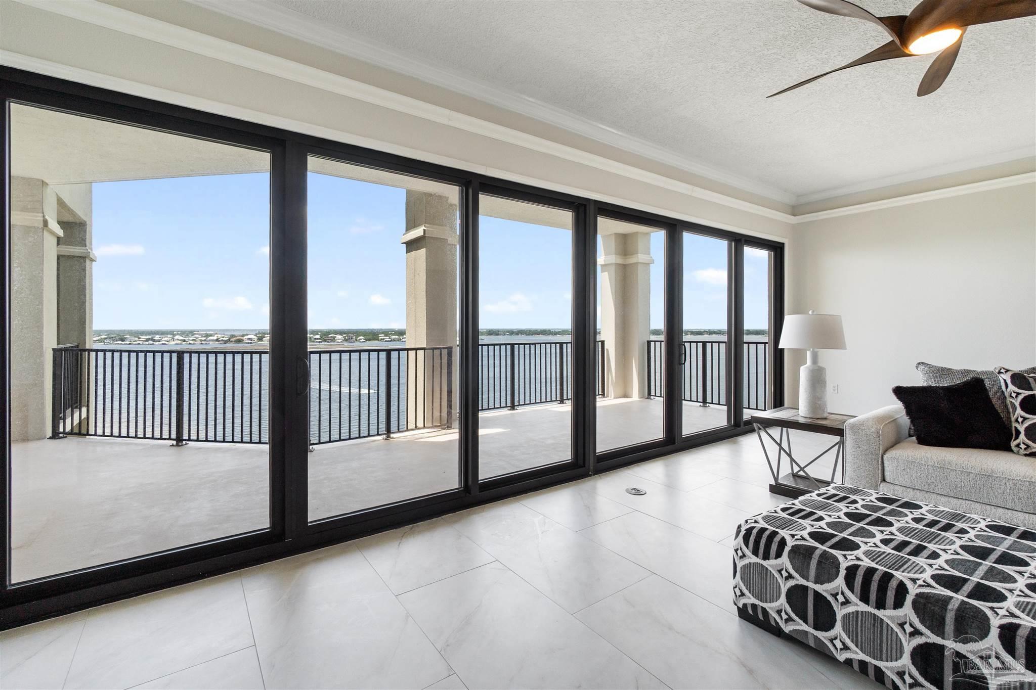 14900 River Road, Unit 904 Pensacola, FL 32507 - Photo 2 of 17 a bedroom with furniture and large windows