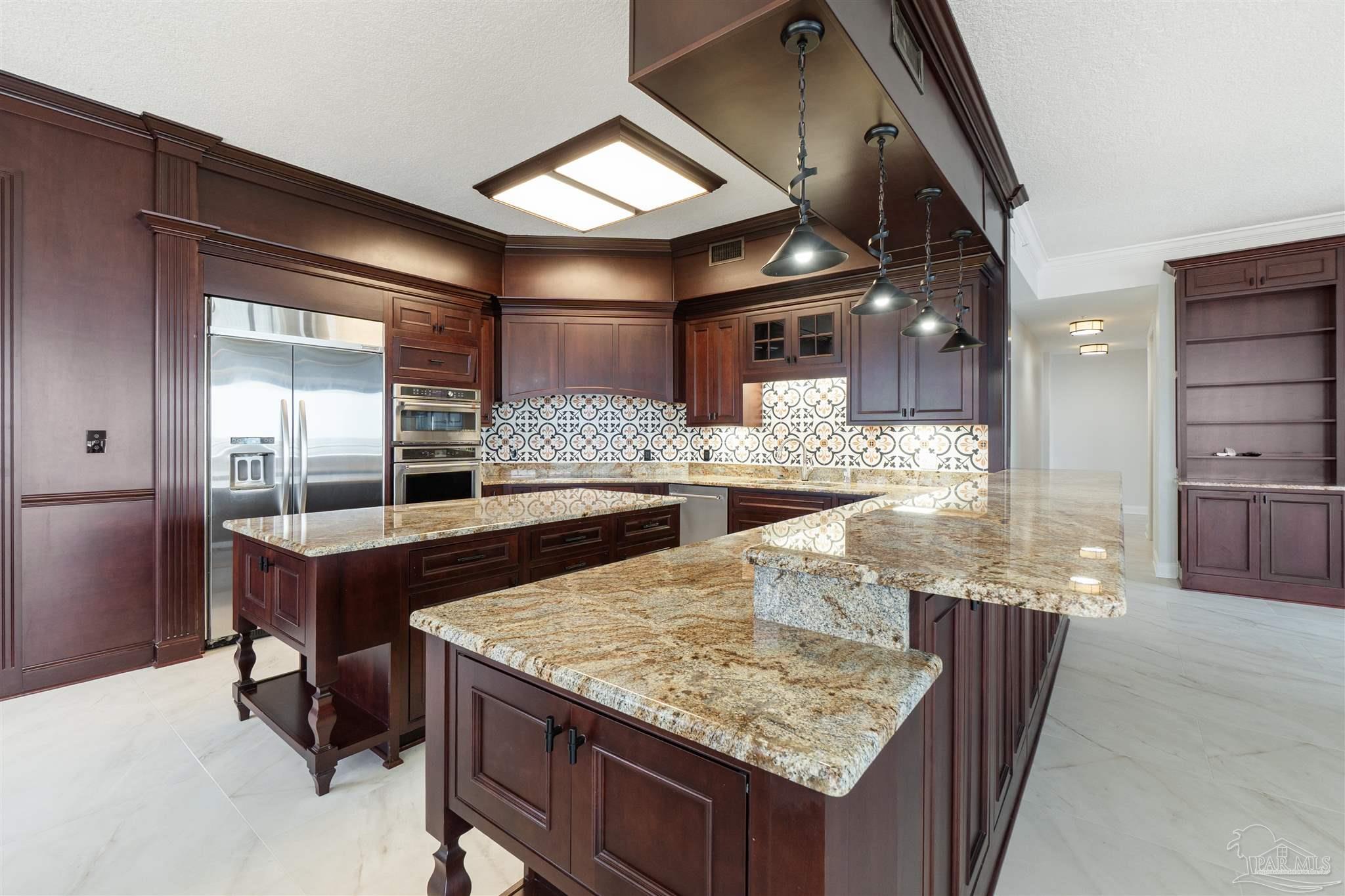 14900 River Road, Unit 904 Pensacola, FL 32507 - Photo 8 of 17 a dining hall with granite countertop kitchen island stainless steel appliances and a counter top space
