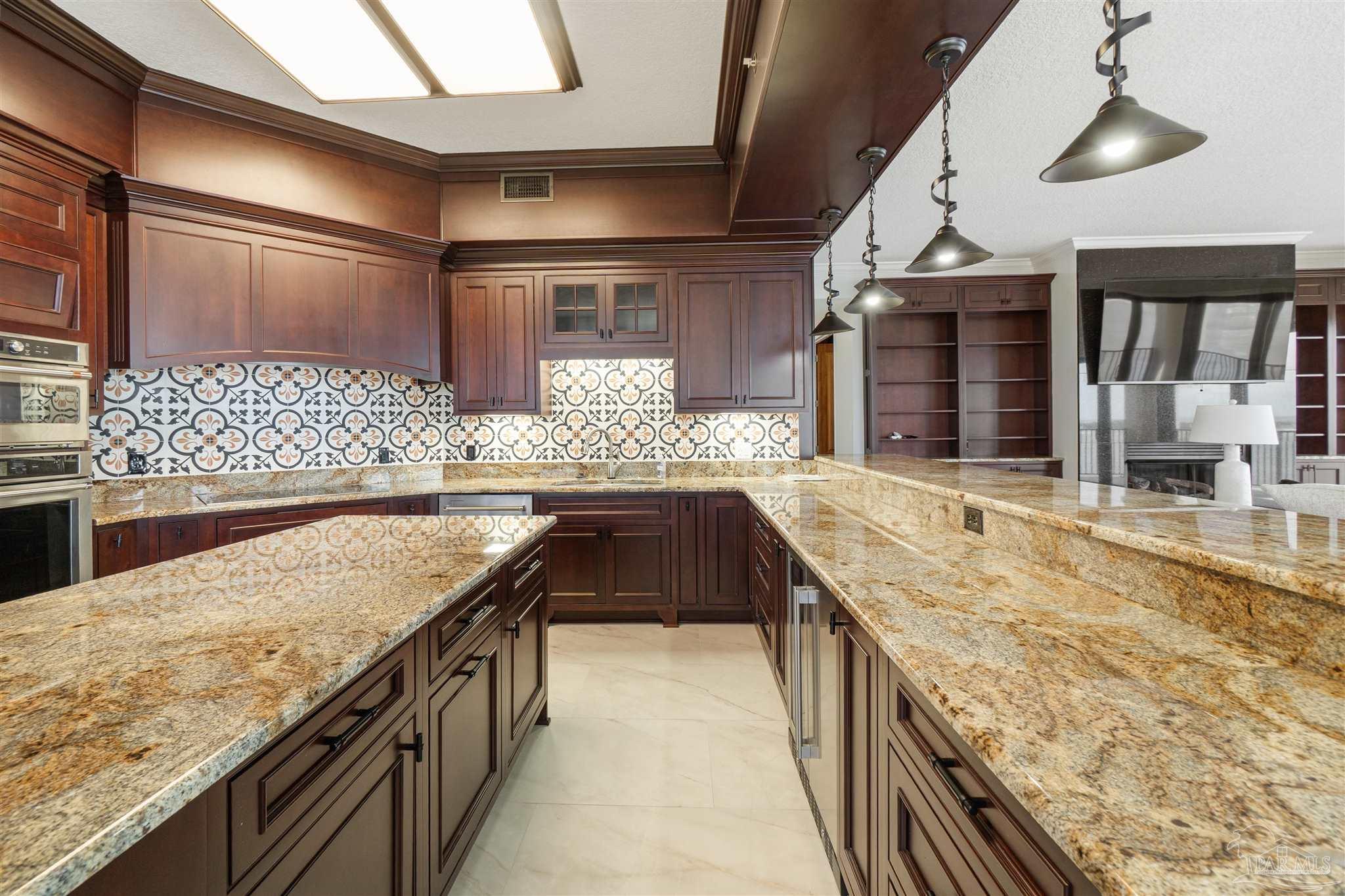 14900 River Road, Unit 904 Pensacola, FL 32507 - Photo 9 of 17 a kitchen with stainless steel appliances granite countertop a sink and stove