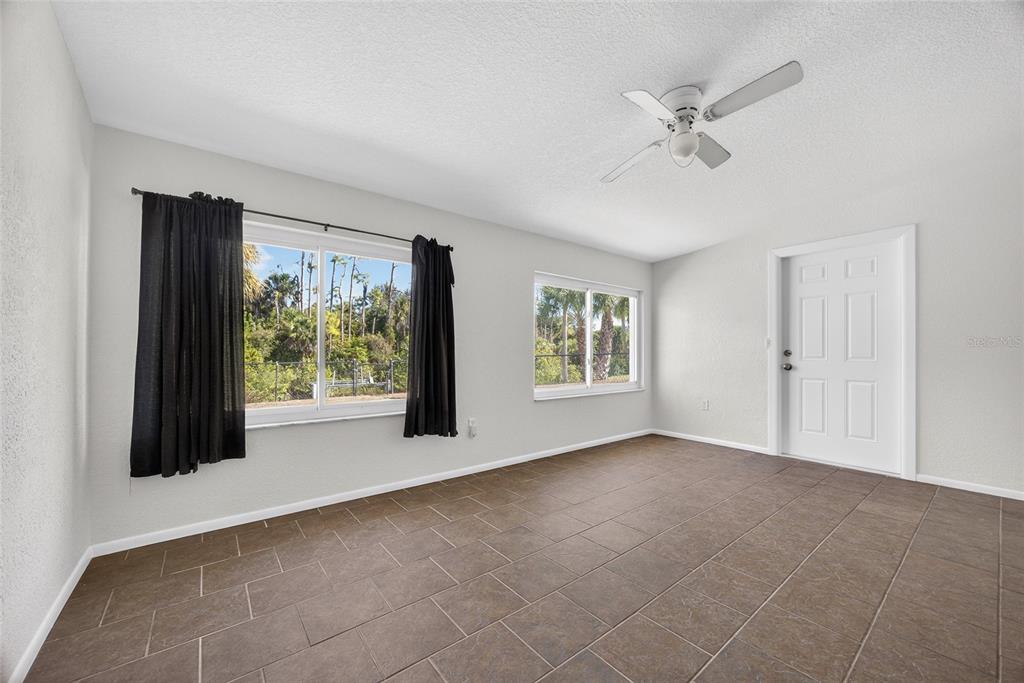 2136 Barksdale Street Port Charlotte, FL 33948 - Photo 14 of 33 a view of a livingroom with a ceiling fan and a window