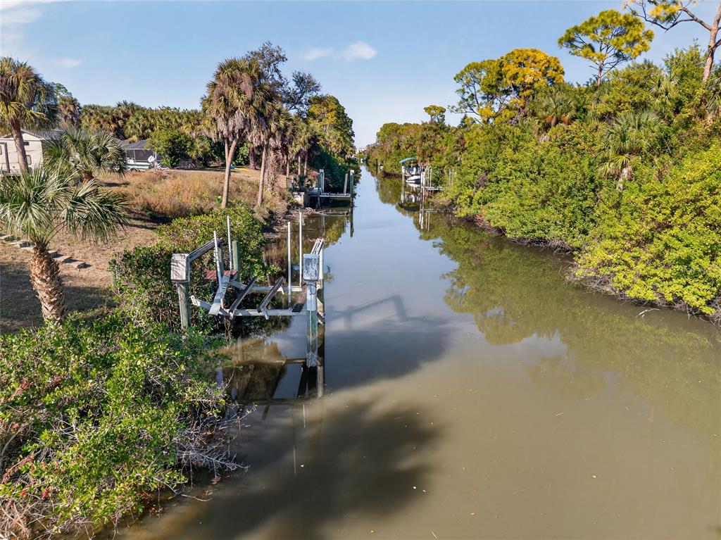 2136 Barksdale Street Port Charlotte, FL 33948 - Photo 25 of 33 a view of a house with a yard and a pond