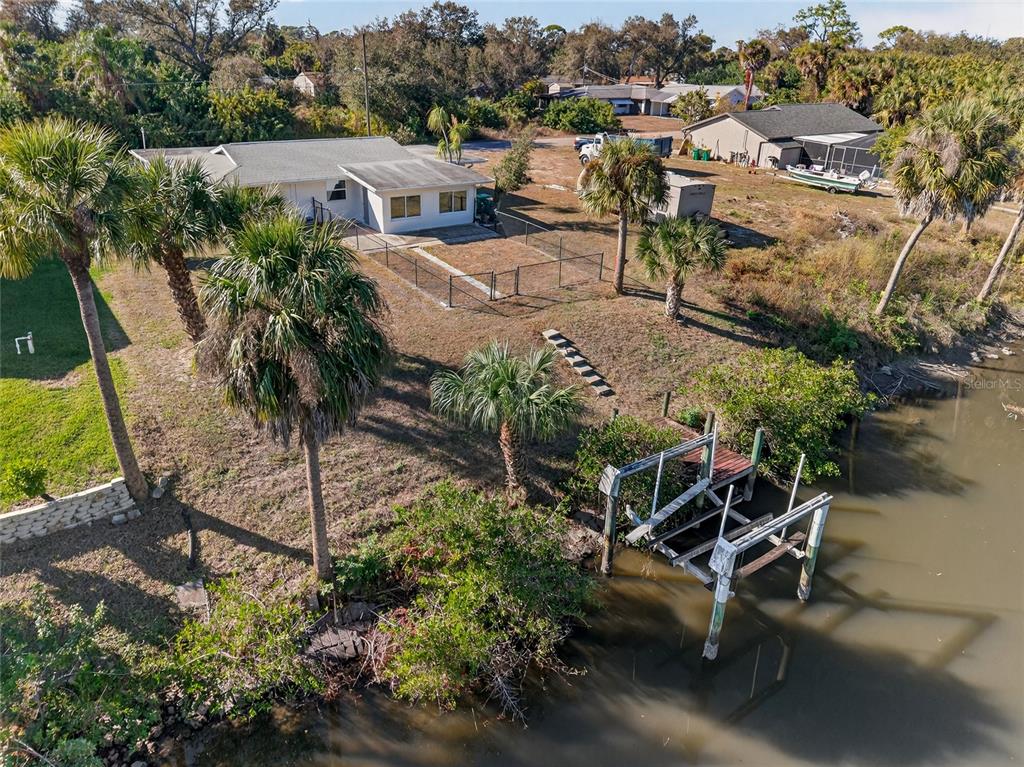 2136 Barksdale Street Port Charlotte, FL 33948 - Photo 27 of 33 an aerial view of a backyard with plants and lake view