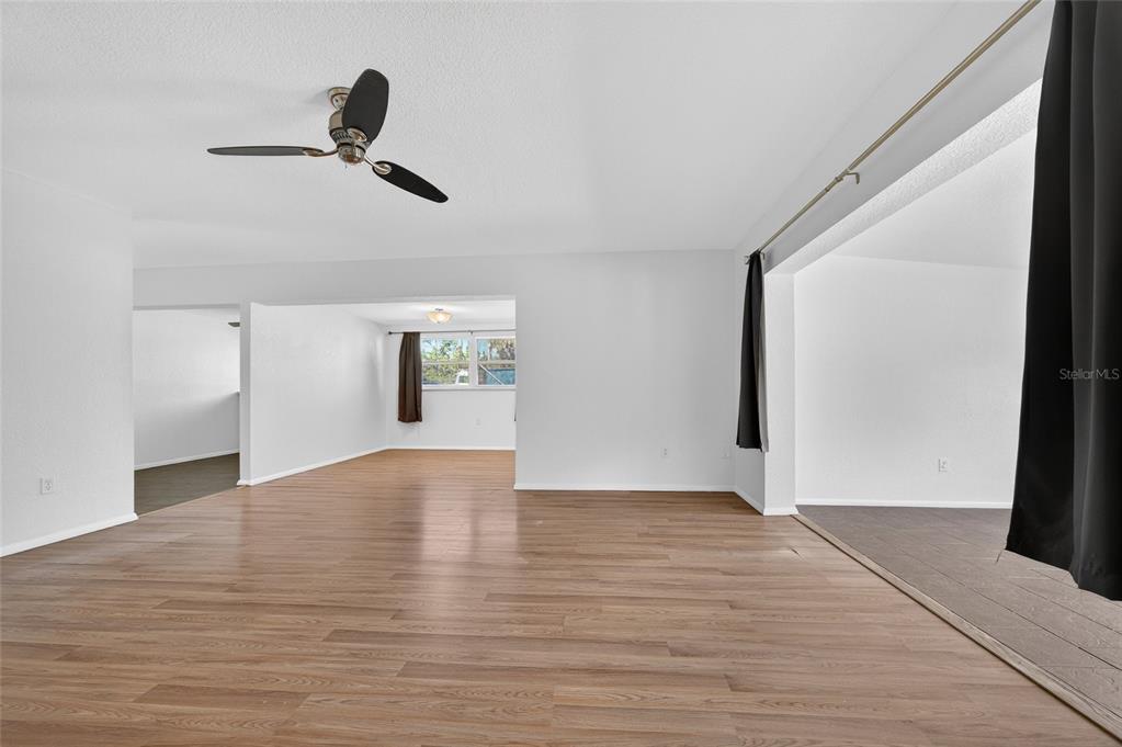 2136 Barksdale Street Port Charlotte, FL 33948 - Photo 4 of 33 a view of empty room with wooden floor and fan