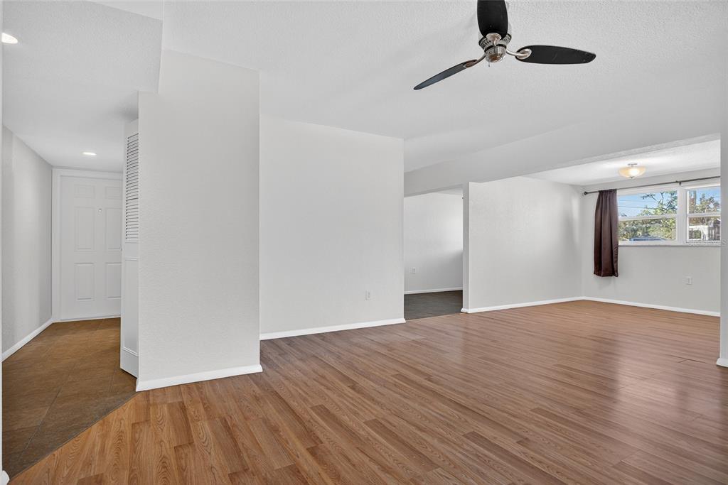2136 Barksdale Street Port Charlotte, FL 33948 - Photo 5 of 33 a view of empty room with wooden floor and fan