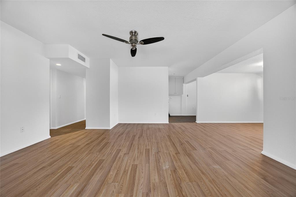 2136 Barksdale Street Port Charlotte, FL 33948 - Photo 6 of 33 a view of empty room with wooden floor and fan