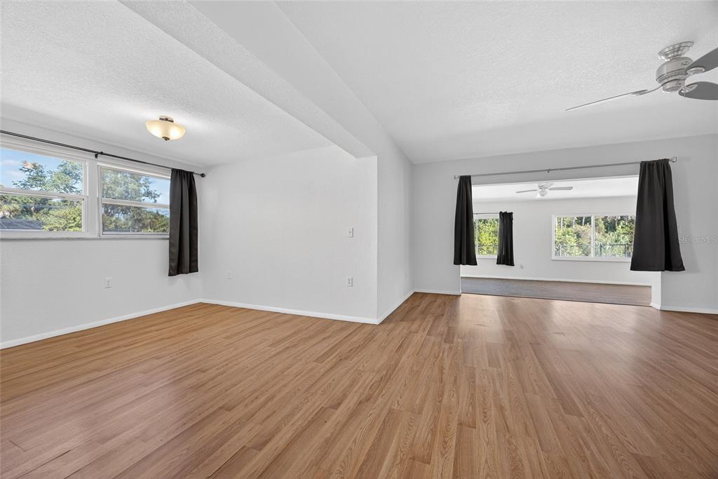 2136 Barksdale Street Port Charlotte, FL 33948 - Photo 7 of 33 a view of an empty room with wooden floor and a window