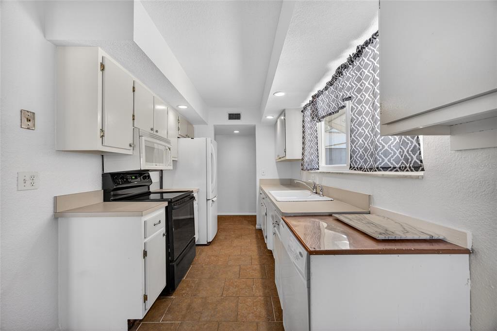 2136 Barksdale Street Port Charlotte, FL 33948 - Photo 10 of 33 a kitchen with stainless steel appliances granite countertop a stove and a refrigerator