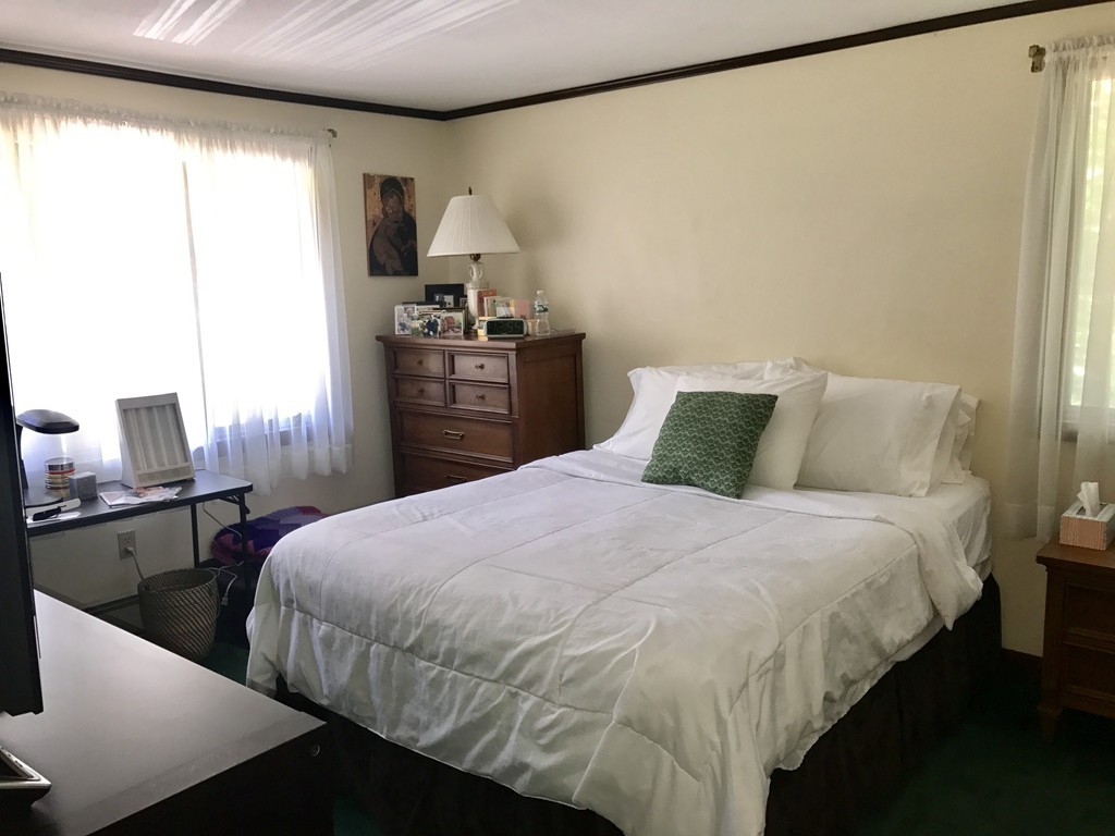 7 Van Beal Road Randolph, MA 02368 - Photo 11 of 22 a bedroom with a bed and wooden floor