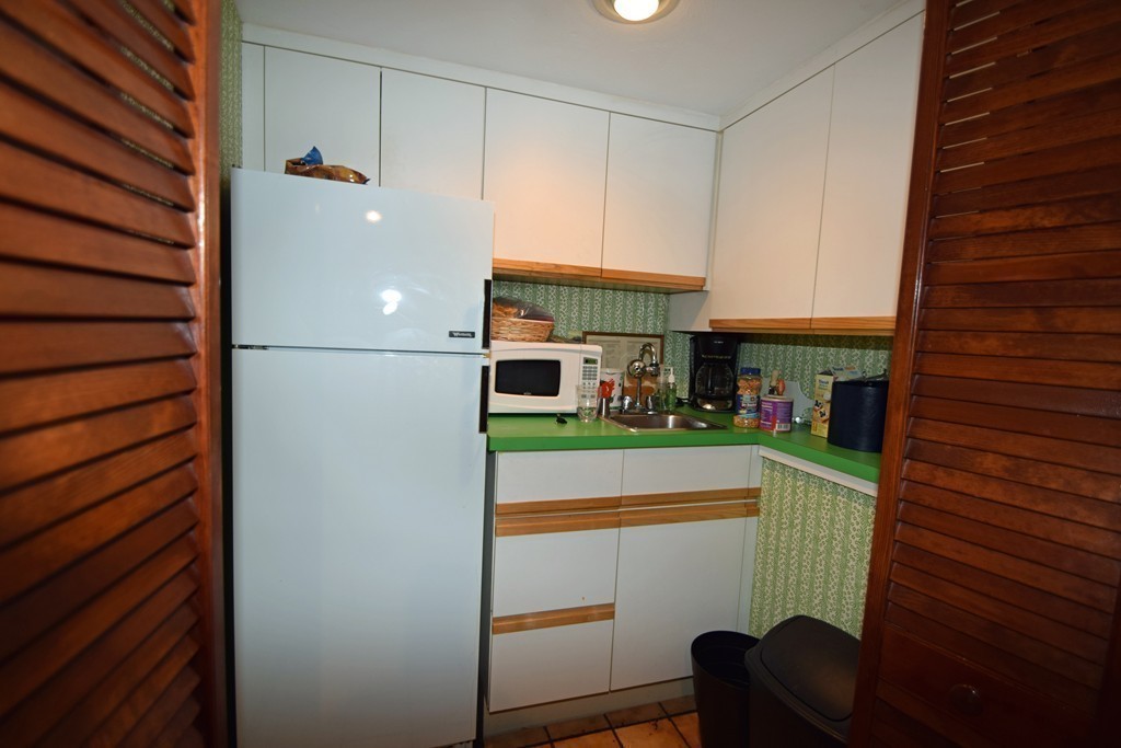 7 Van Beal Road Randolph, MA 02368 - Photo 16 of 22 a kitchen with a refrigerator and cabinets
