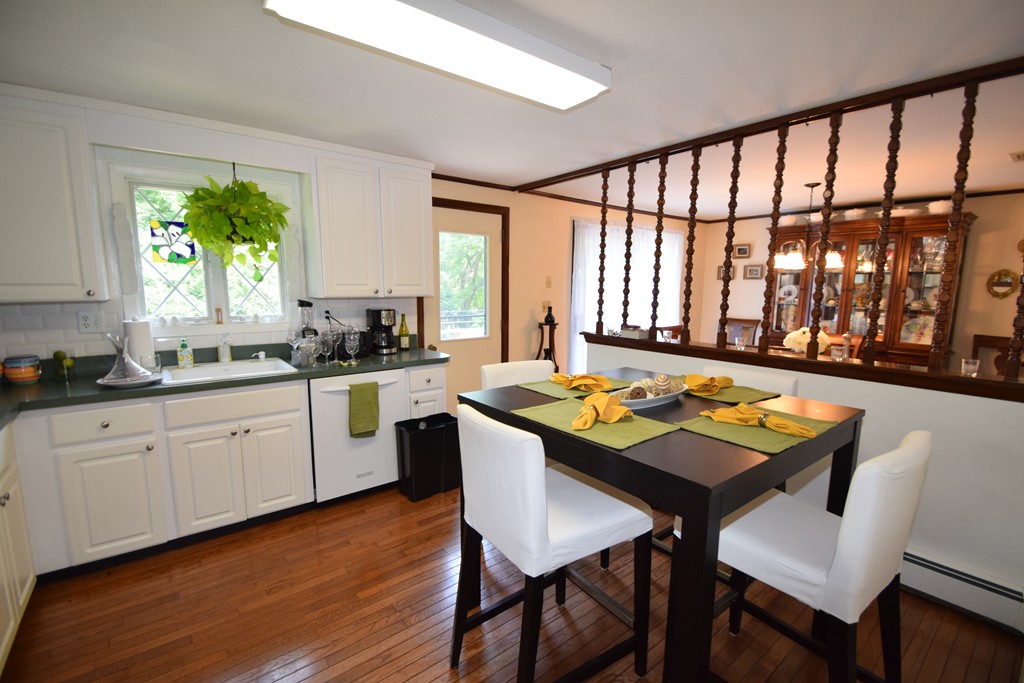 7 Van Beal Road Randolph, MA 02368 - Photo 5 of 22 a kitchen with a table chairs sink and cabinets