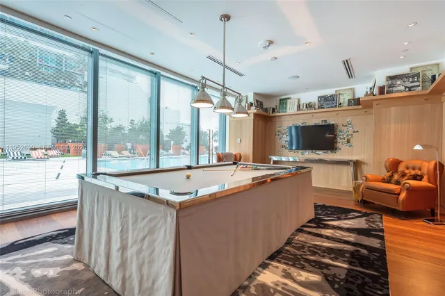 a large kitchen with kitchen island a large window in it