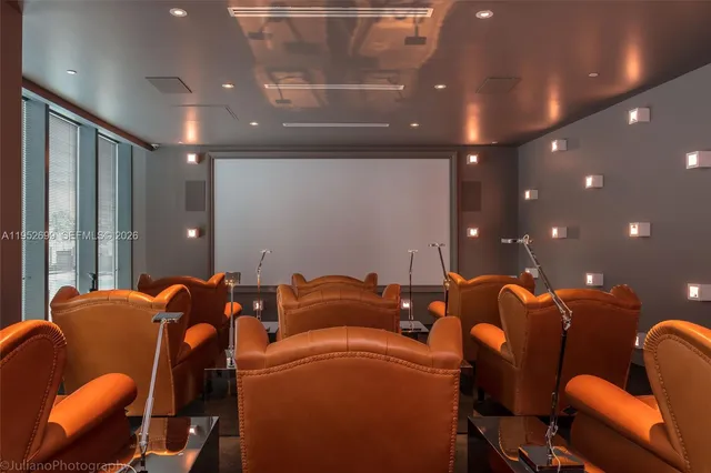 a media room with lots of chairs and mirrors